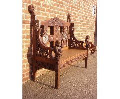 A Celtic Arts & Crafts carved Oak settle with carved dragons to the tops - Thumbnail 2