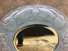 An Arts & Crafts pewter mirror with decorative heart and abstract line details - Thumbnail 2
