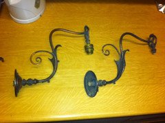 A pair of Arts & Crafts wall lights with floral leaf and scroll work decoration to the arms. - Thumbnail 1