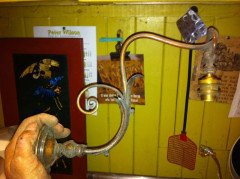 A pair of Arts & Crafts wall lights with floral leaf and scroll work decoration to the arms. - Thumbnail 4