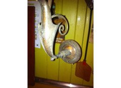 A pair of Arts & Crafts wall lights with floral leaf and scroll work decoration to the arms. - Thumbnail 5