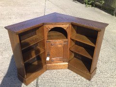 Liberty & Co. An Arts & Crafts Oak corner bookcase - Thumbnail 2