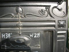 An Arts & Crafts fireplace with stylized floral details - Thumbnail 3