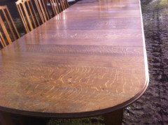 A fourteen seat Arts & Crafts Oak 'D' end extending dining table with four extra leaves. - Thumbnail 4