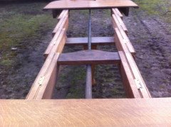 A fourteen seat Arts & Crafts Oak 'D' end extending dining table with four extra leaves. - Thumbnail 6