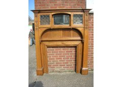 An Arts & Crafts Oak fire surround with egg and dart mouldings central mirror - Thumbnail 1