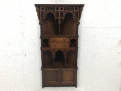 Liberty & Co. A walnut corner cupboard in the Moorish style. - Thumbnail 1