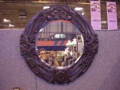 A large Arts and Crafts oak mirror with floral carving of superior craftsmanship. - Thumbnail 1