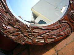 A large Arts and Crafts oak mirror with floral carving of superior craftsmanship. - Thumbnail 5
