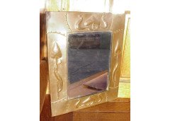 Liberty & Co. Attributed, a copper mirror with hand formed stylised floral details. - Thumbnail 1