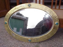 Liberty & Co. A rare Arts & Crafts brass oval mirror - Thumbnail 1