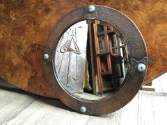 Liberty & Co., Style of. An Arts & Crafts circular copper mirror inset with four turquoise and red Ruskin jewels. - Thumbnail 1