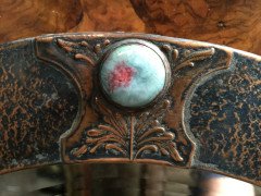 Liberty & Co., Style of. An Arts & Crafts circular copper mirror inset with four turquoise and red Ruskin jewels. - Thumbnail 2