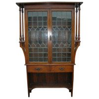 Liberty & Co., an Arts & Crafts Oak Glazed Bookcase with Stylized Heart Details