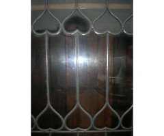 Liberty & Co., an Arts & Crafts Oak Glazed Bookcase with Stylized Heart Details - Thumbnail 7