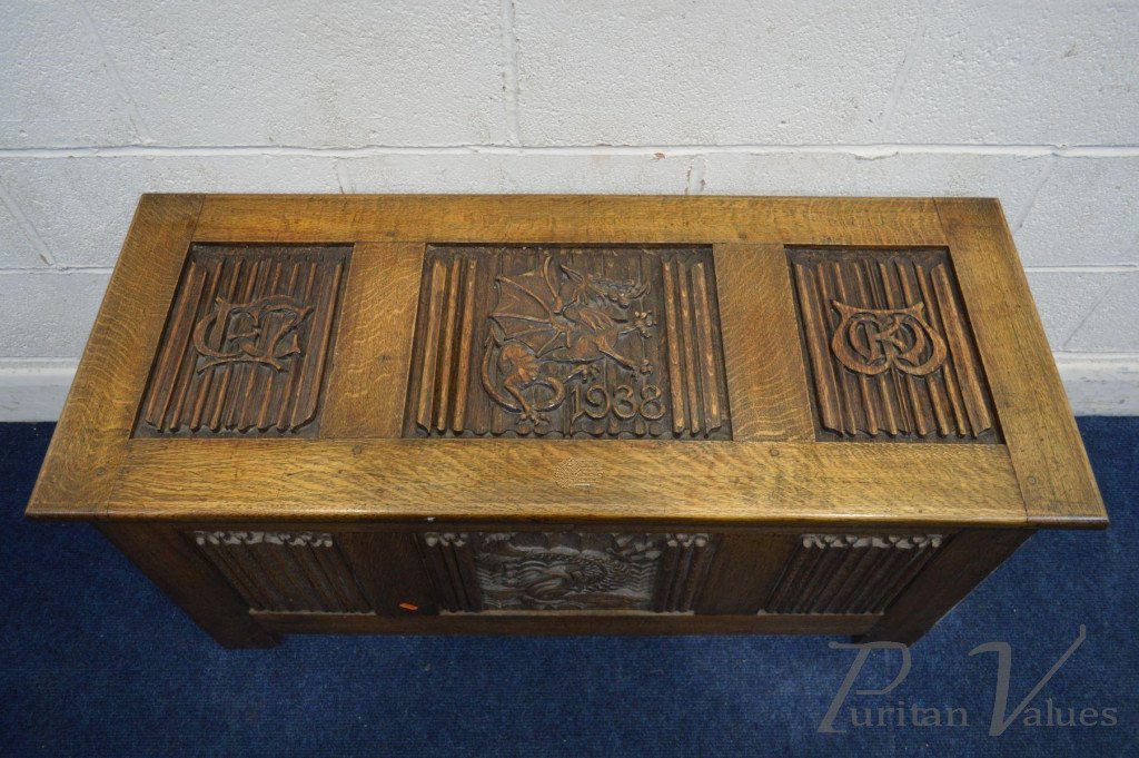 Oak_Blanket_Chest_with_linenfold_panels_to_all_sides_carved_dragons_to_the_top_and_front_date_reading_1938_two_initials_to_the_lid_W112cm_D46cm_H56cm__master