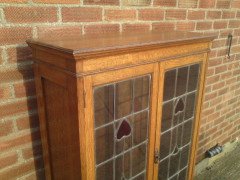 Arts & Crafts Oak Bookcase with Stylized Floral Stain Glass and a Cupboard below - Thumbnail 6