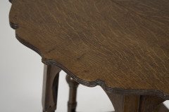 Liberty and Co. An Arts and Crafts oak side or occasional table with a shaped top and molded edges - Thumbnail 11