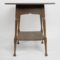 Liberty & Co., attributed. An Arts & Crafts Oak Two-tier Side Table with a Moorish Apron Underneath the Top - Thumbnail 2