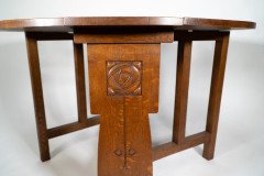 Liberty & Co., An Arts & Crafts 1/4 Salon Oak Drop Leaf Table with Stylised Floral Carved Decoration - Thumbnail 11