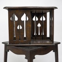 Liberty & Co., An Arts & Crafts Oak Revolving Bookcase with Stylized Floral Cut-out Decoration - Thumbnail 6