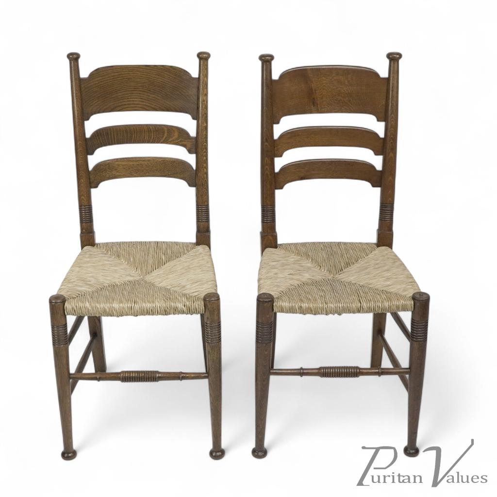 Liberty & Co., A Pair of William Birch Arts & Crafts Oak Rush Seat Dining Chairs - Image 1