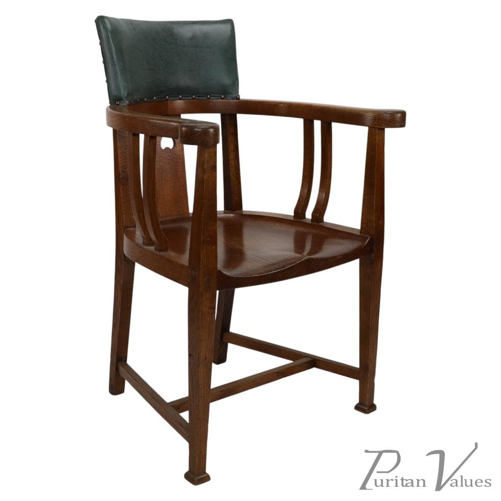 E. A. Taylor, attributed. An Arts & Crafts Oak Tub Chair with a Pierced Heart - Image 1