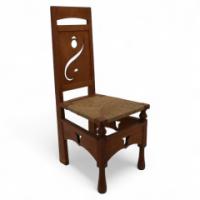 M. H. Baillie Scott Attributed, an Arts & Crafts Oak Chair with Stylized Floral Cut-outs