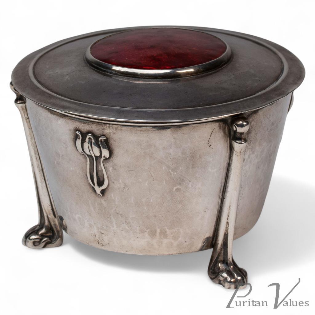 Edith Dawson. An Arts & Crafts Silver Pot with Floral Details & a Red Enamel Lid - Image 1