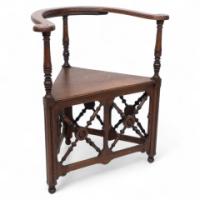 Jas Shoolbred. An Aesthetic Movement Oak Corner Armchair with Stylized Turnings