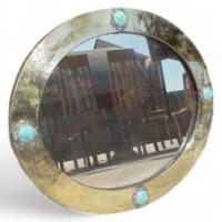 Liberty & Co. A brass mirror with four Ruskin ceramic discs rivetted into place. - Thumbnail 1