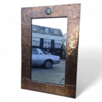 Liberty & Co. An Arts & Crafts copper mirror with a little blue Ruskin jewel to the top. - Thumbnail 1