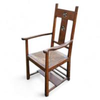 An Arts and Crafts Cotswold School armchair with lower shelf and pierced floral detail - Thumbnail 1