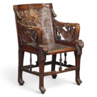 An early Egyptian Revival carved walnut elbow chair - Thumbnail 1