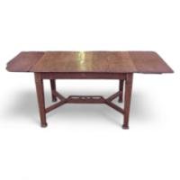 In the style of John Ednie. An Arts & Crafts Oak Inlaid Extending Dining Table.