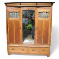 Goodhall, Lambs and Heighway. A Glasgow School Arts & Crafts Oak treble wardrobe in the manner of M. H. Baillie Scott - Thumbnail 1
