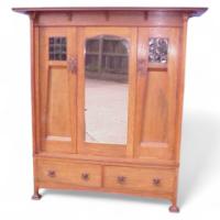 Harris Lebus. An Arts & Crafts Oak treble wardrobe in the Glasgow Style - Thumbnail 1