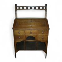 Liberty & Co., an Oak Bureau in the Moorish Style with Moucharabieh Turning
