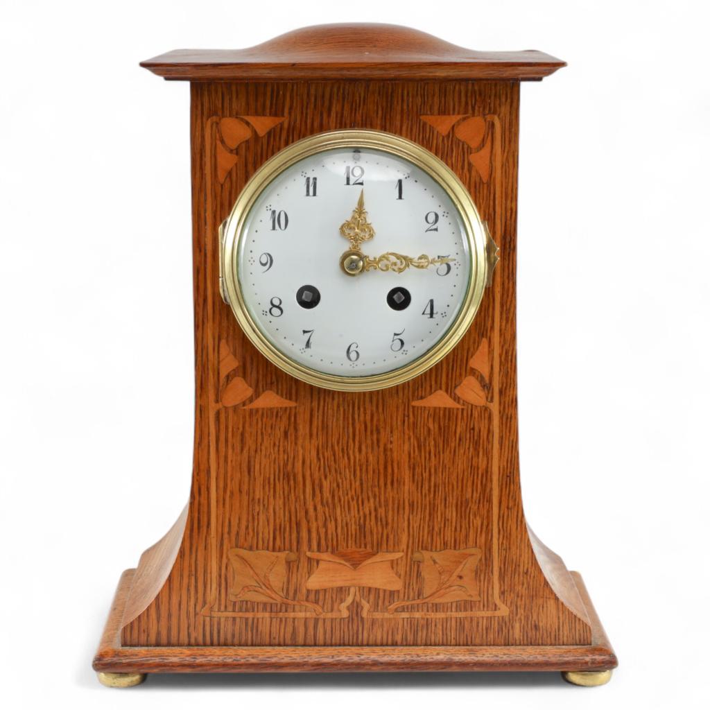 Liberty & Co., Liberty & Co., An Arts & Crafts Oak Mantle Clock with Floral Inlay