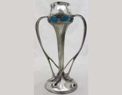 Liberty & Co. A Tudric Pewter and Enamel organic vase with blue/green enamel roundels to the top and twin whiplash handles. - Thumbnail 1
