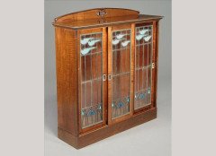 George Logan for Wylie & Lochhead. A carved walnut display cabinet - Thumbnail 1