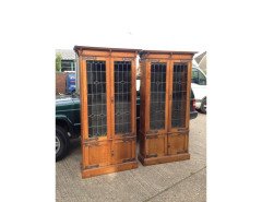 A pair of Arts & Crafts Oak glazed bookcases over a lower cupboard - Thumbnail 1