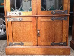A pair of Arts & Crafts Oak glazed bookcases over a lower cupboard - Thumbnail 3