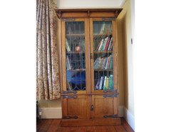 A pair of Arts & Crafts Oak glazed bookcases over a lower cupboard - Thumbnail 9
