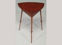 Liberty & Co. Attributed, a mahogany triform occasional table In the style of E. W. Godwin - Thumbnail 1