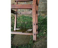 An Arts & Crafts Cotswold School Armchair with lower shelf and pierced floral detail - Thumbnail 4