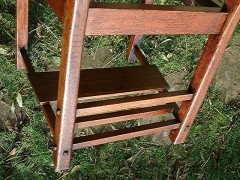 An Arts & Crafts Cotswold School Armchair with lower shelf and pierced floral detail - Thumbnail 5